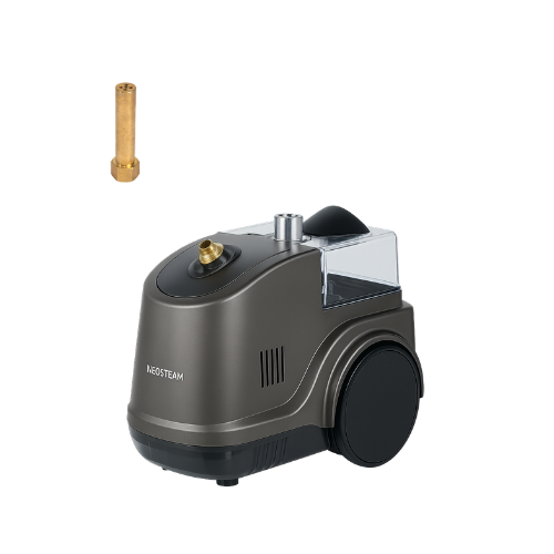Compact steam/humidifier-style device with a clear water reservoir and a detachable brass nozzle nearby.