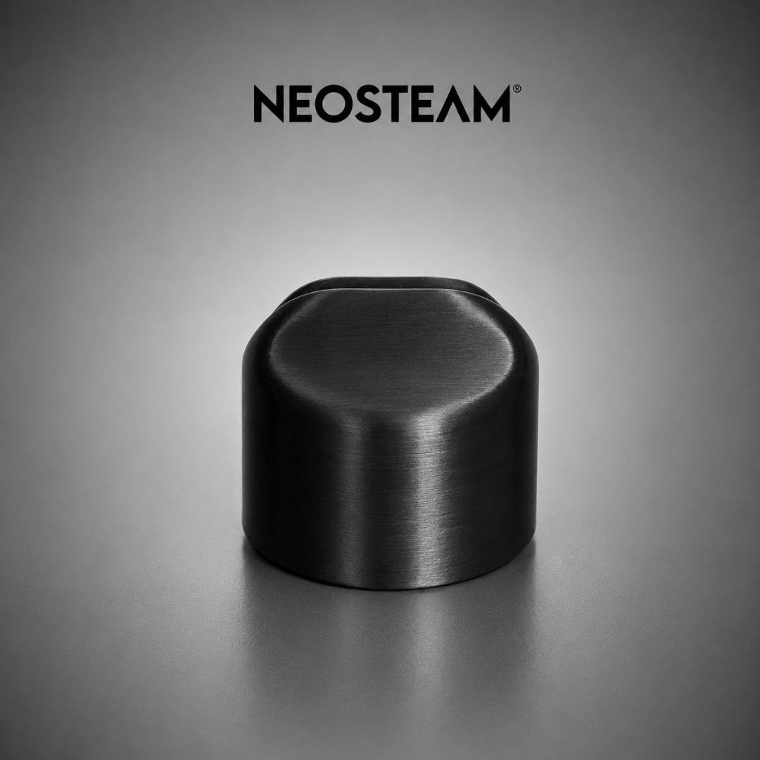 92 - NeoSteam Black brushed metal cylindrical knob on a gray surface with the Neostem logo above.