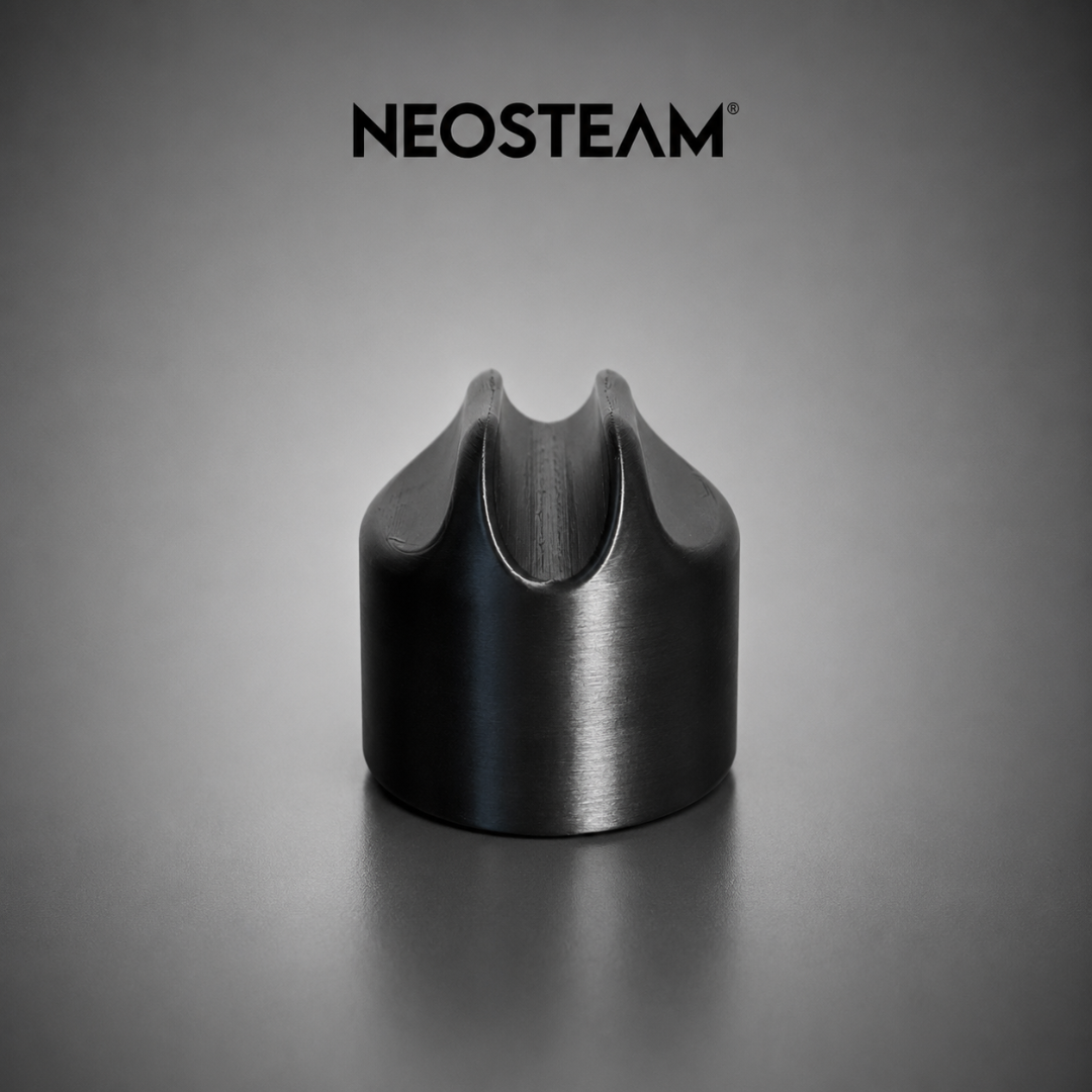 95 - NeoSteam Close-up of a black metal crown-shaped nozzle with a U-shaped notch on a gray backdrop, NEOSTEAM logo above.