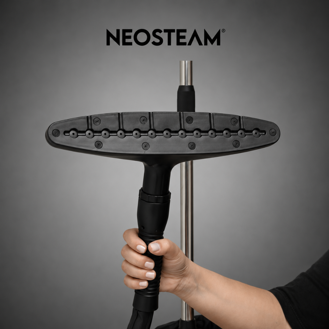 12 2 1 - NeoSteam Hands gripping a steam mop handle with a wide black flat cleaning head; NEOSTEAM logo appears above.