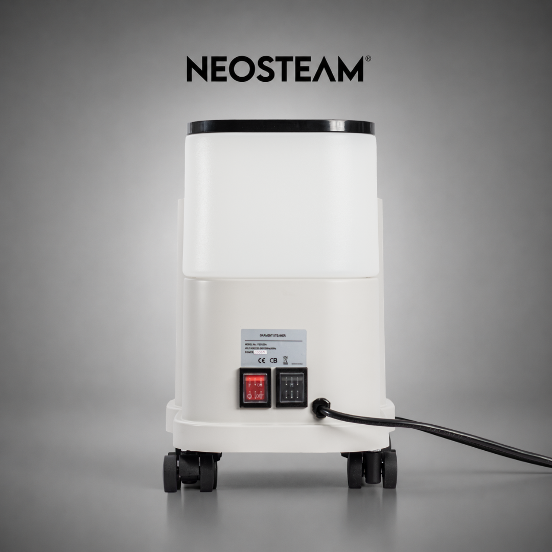 26 1 - NeoSteam Back view of a white garment steamer on wheels with red and black switches and a power cord, NEOSTEAM logo above.