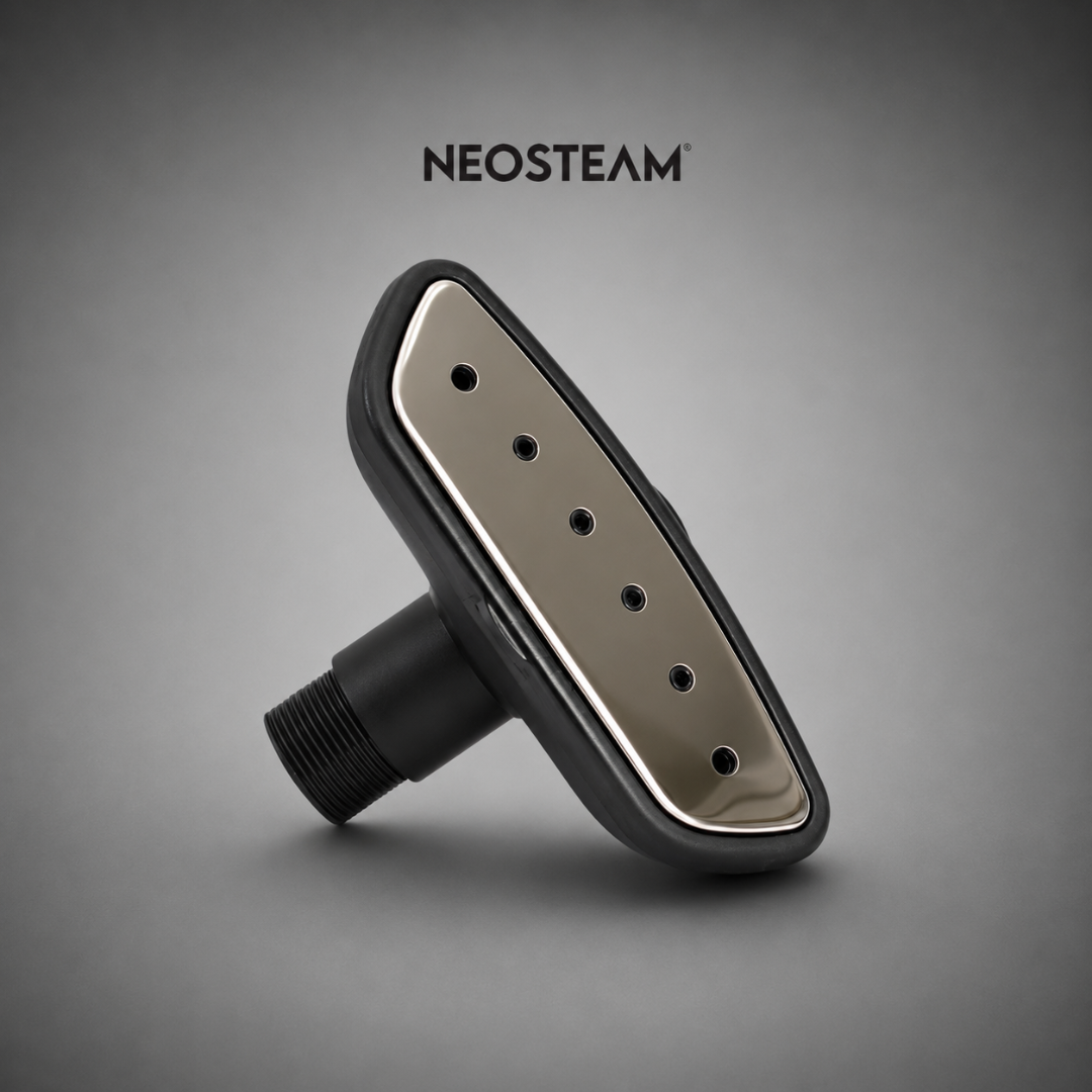 59 - NeoSteam Neosteam handheld garment steamer head with a metallic soleplate and multiple steam vent holes on a gray background, angled for emphasis